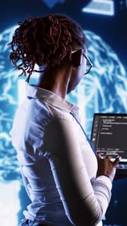 Woman Uses Laptop Pointing at Futuristic Digital Screen