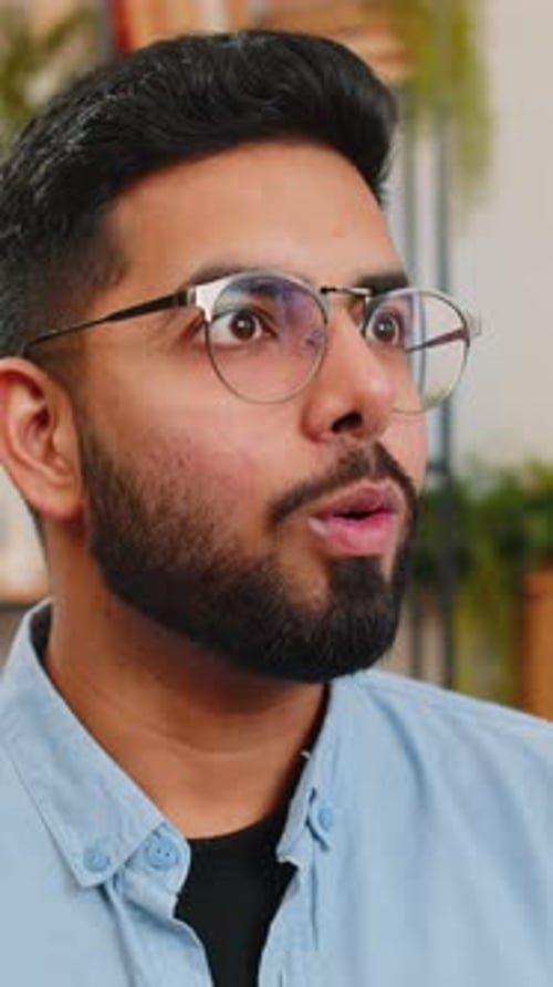 Surprised Man Reacts with Shock and Excitement Indoors