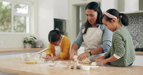 Woman and Children Baking Together in Kitchen