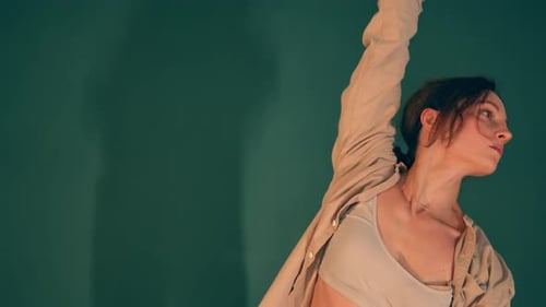 Closeup of Young Caucasian Professional Ballerina Practicing Contemporary Modern Ballet in a Studio
