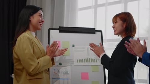 Business Team Celebrates Success at Work