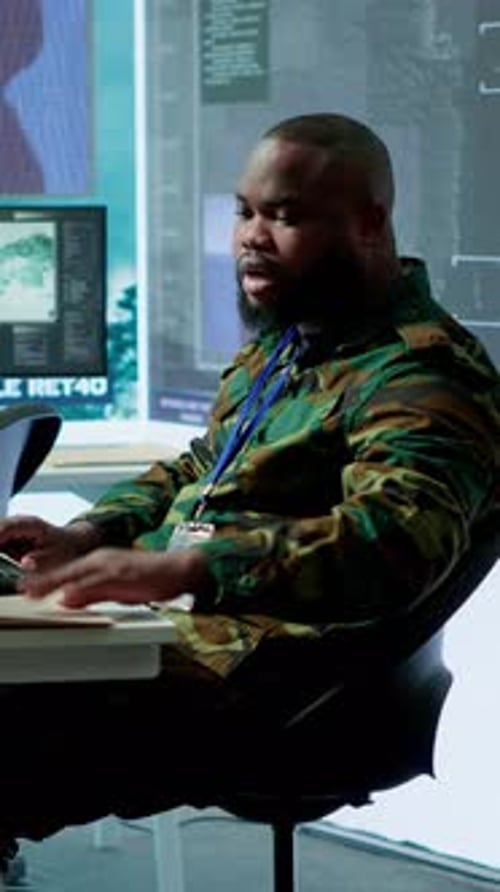 Man Works at Computer in Darkened Office