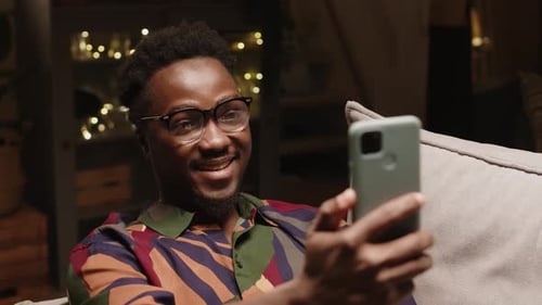 Man Video Chatting at Home in Living Room