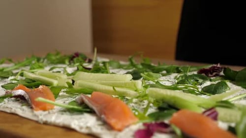 Preparing Flatbread Dish with Salmon, Greens and Cucumber