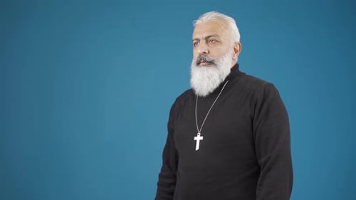 Man Makes Sign of the Cross Wearing Silver Cross