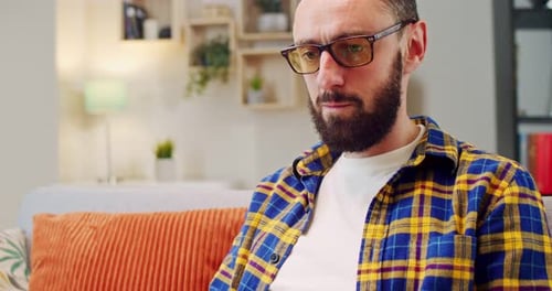Close Up of Caucasian Man Sitting on Cozy Sofa in Living Room and Working on Laptop Male Working As