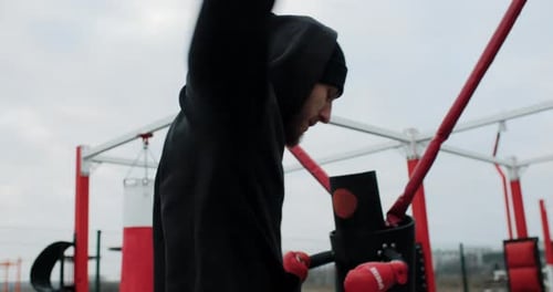 Work Out Motivation Medium Shot of Athlete Man Warming Up Outside on the Outdoor Gym Strong Fit Man