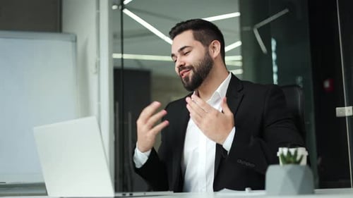 Smiling Man Video Conferencing in Modern Office