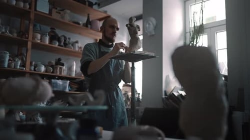 Fulllength Portrait of a Skillful Man Potter Creating a Clay Statue in His Author's Art Workshop