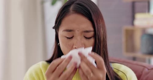 Woman Blowing Nose with Tissue While Sick