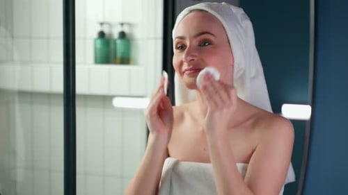Woman Removing Makeup in Bright Bathroom