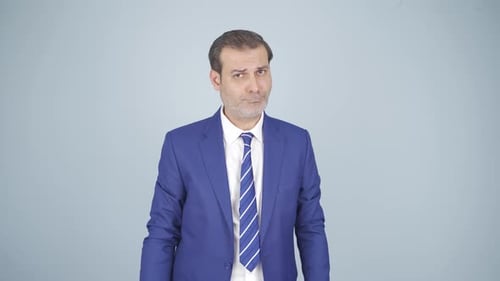 Man in Blue Suit Speaking and Gesturing