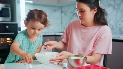 Child and Woman Baking Together in Kitchen