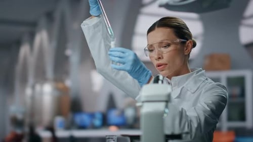Female Scientist Working with Test Tubes in Bright Lab