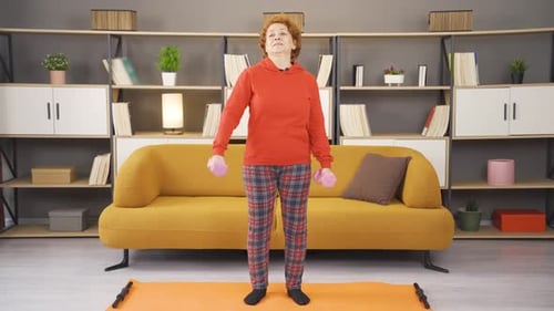 Fit woman lifting weights with dumbbells.