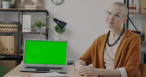 Slow Motion Portrait of Creative Lady Looking at Green Screen Chroma Key Laptop Then Turning to