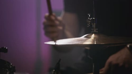 A Young Caucasian Man Drummer Plays in a Music Studio