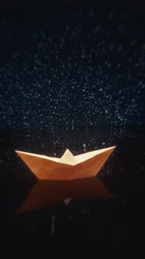 Paper Boat Floating In Starry Ocean At Night