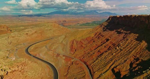 Rocky scenery of amazing canyons in Utah, USA. Motorway leading to the green valley.