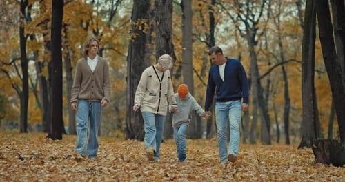 Fulllength Portrait of Happy Family Walking in Beautiful Park in Autumn Day Prores
