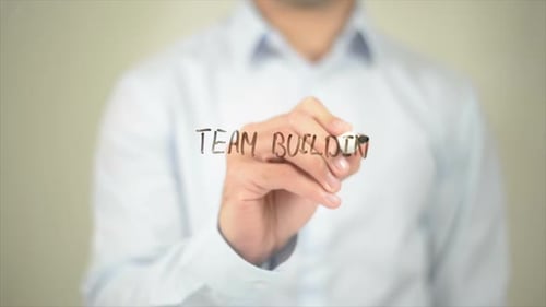Team Building Man Writing on Transparent Screen