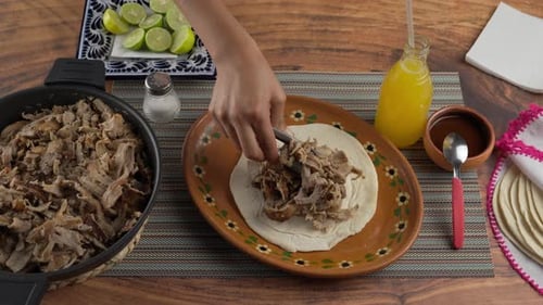 Assembling Delicious Meat Tacos on Traditional Plate