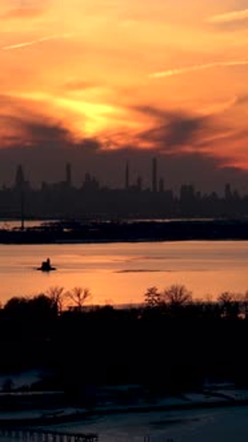 Beautiful golden hour sunset painting the sky with orange and yellow hues above the silhouetted new