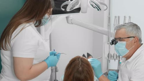 Dentists and Dental Assistants Work Together to Offer Patient Care in a Dental Clinic Combining