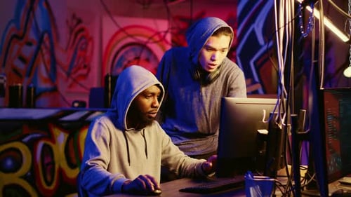Two Young Adults Working on Computers at Night