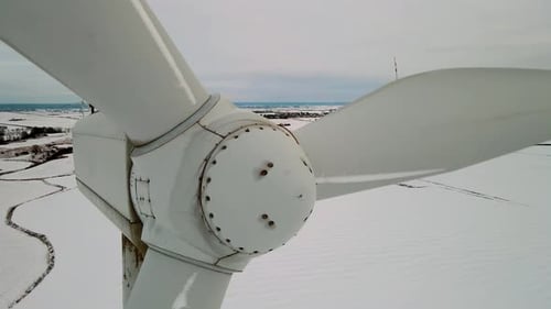 Windmill Farm Generating Green Energy Rotating Blades of Wind Turbines During Cold Winter Sunset