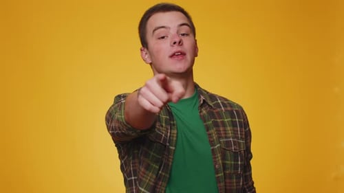 Man Pointing to Camera and Looking with Playful Happy Expression Making Choice Showing Direction