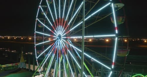 Bright Ferris Wheel Turning at Night