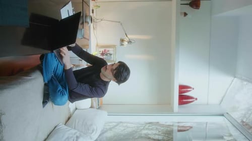 Man Working on Laptop Indoors Bright Home Office