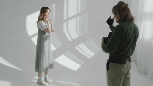 Young Woman Posing on Cyc Wall during Studio Photo Shoot