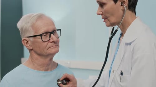 Doctor Examining Senior Patient with Stethoscope in Hospital