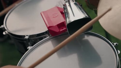 closeup of percussion drums and cowbell played outdoors