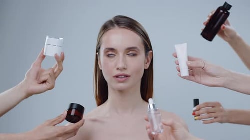 Attractive Woman Surrounded by Beauty Products and Hands