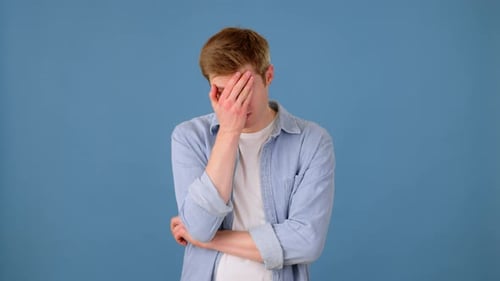 Disappointed Male Shaking Head and Making Face Palm Gesture