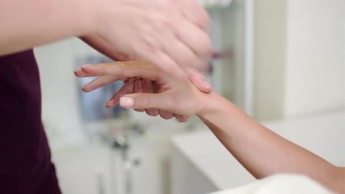 Woman Getting Relaxation Hand Massage in Spa Salon