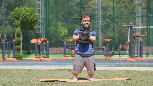 Dwarf young man trying to develop pectoral muscle. body building.