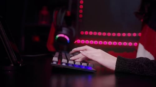Close up of professional Streamer hand on keyboard playing online