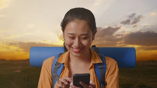 Close Up Of Asian Female Hiker Enjoy Using Smartphone On The Top Of Mountain