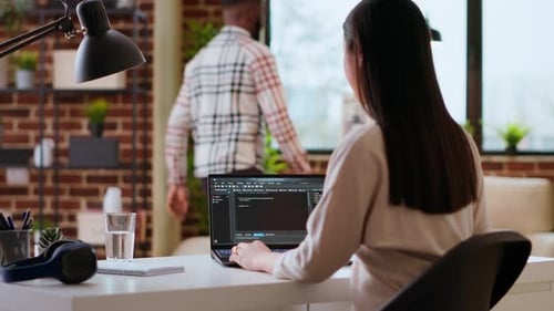 Woman Coding on Laptop in Home Office