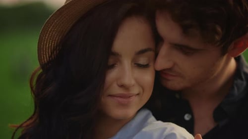 Couple in Love Expressing Tenderness on Meadow at Sunset. Portrait of Charming