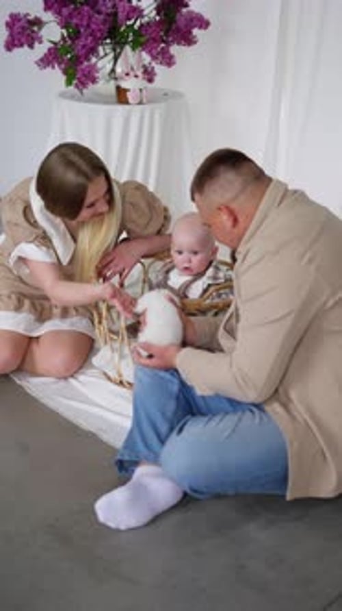 Happy Family with Infant Sitting Together Indoors
