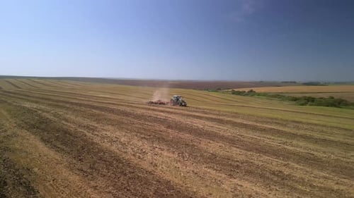 Tractor working on the field doing tillage with cultivator