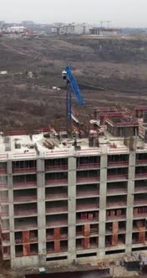 Vertical Aerial Drone Pull Away From Large Residential Construction Site With Tower Cranes