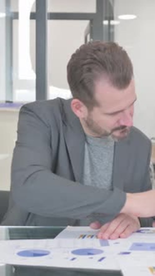 Young People Doing Paperwork in Office, vertical video