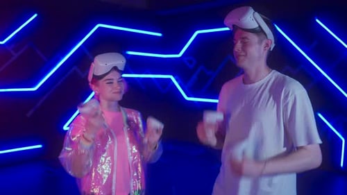 Couple Experiences Virtual Reality in Neon Lit Room