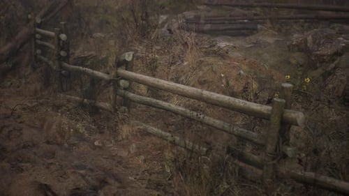 An Old Wood Fence with a Country Field Behind It